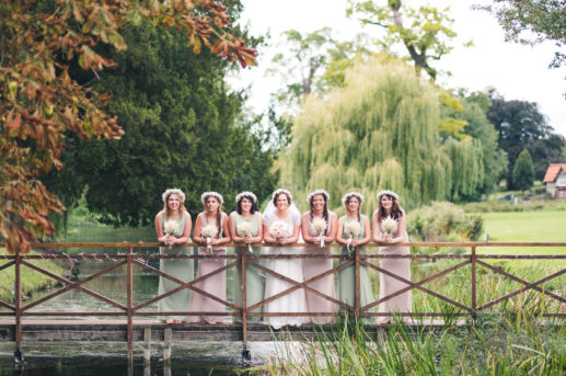 Bride and Bridesmaid on bridge willow tree in background